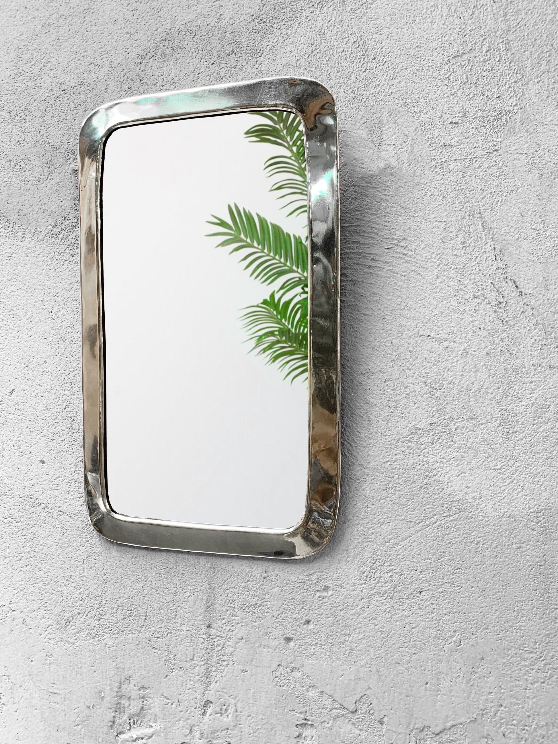 a mirror mounted to the side of a wall