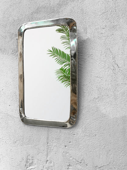 a mirror mounted to the side of a wall