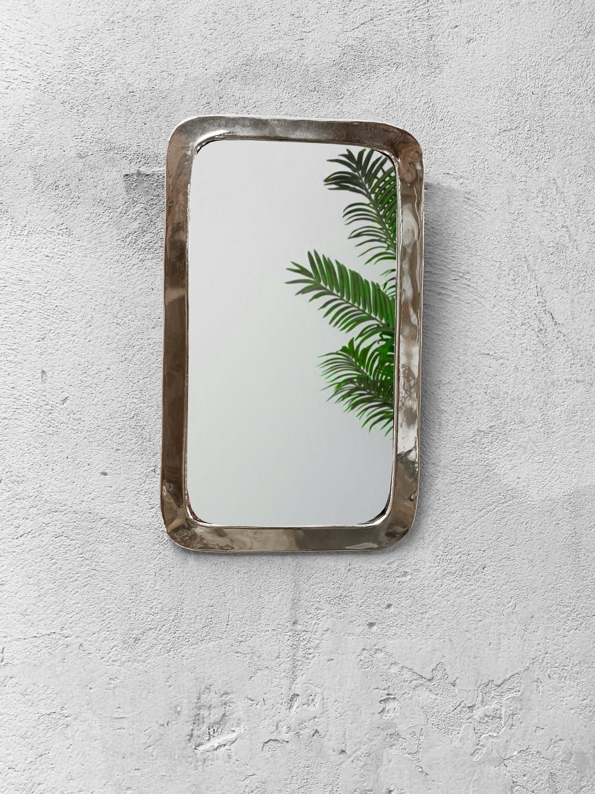 a mirror mounted to the side of a wall