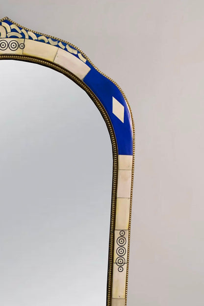 a mirror with a blue and white border around it