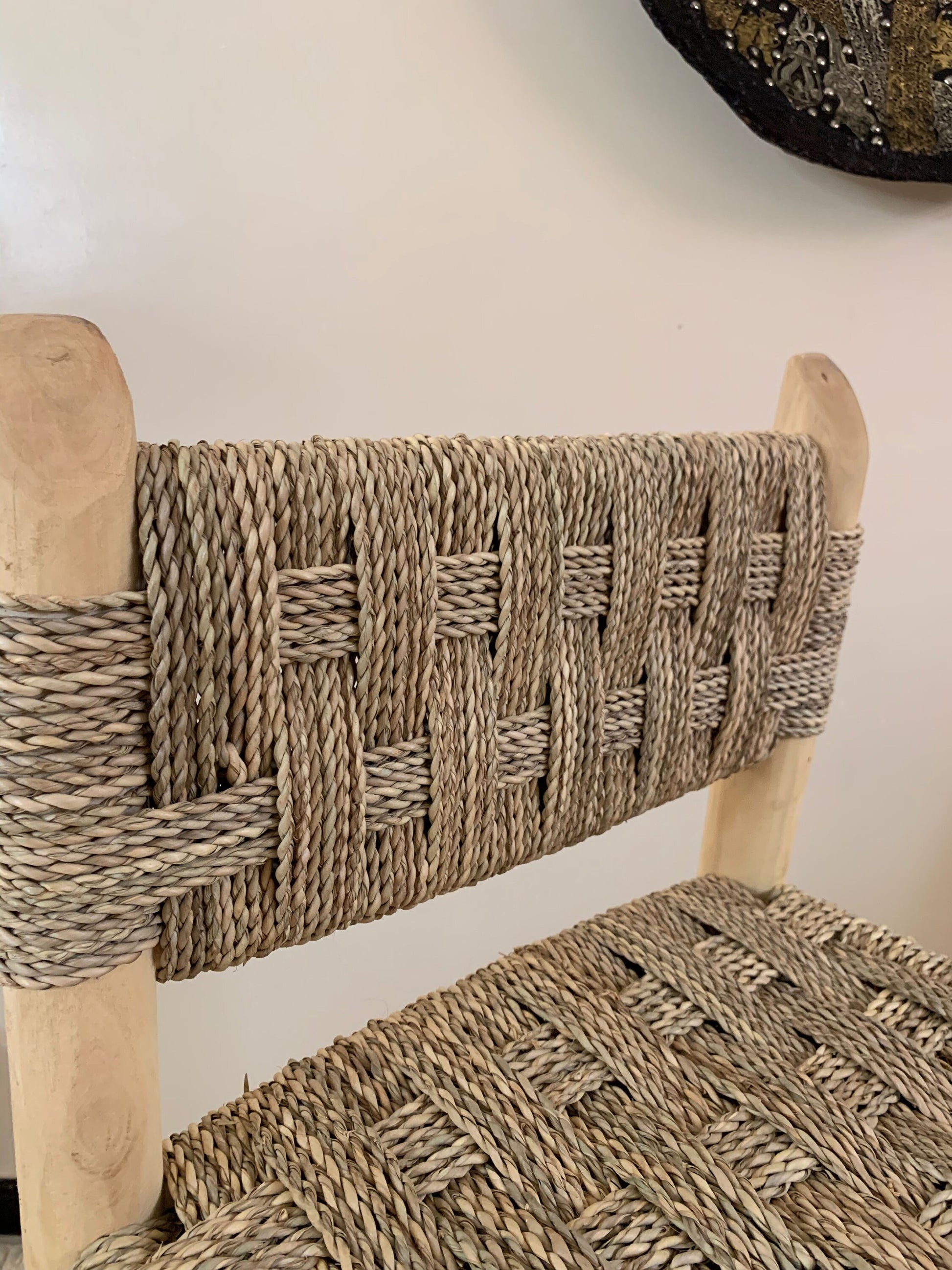 a wicker chair with a wooden seat and back