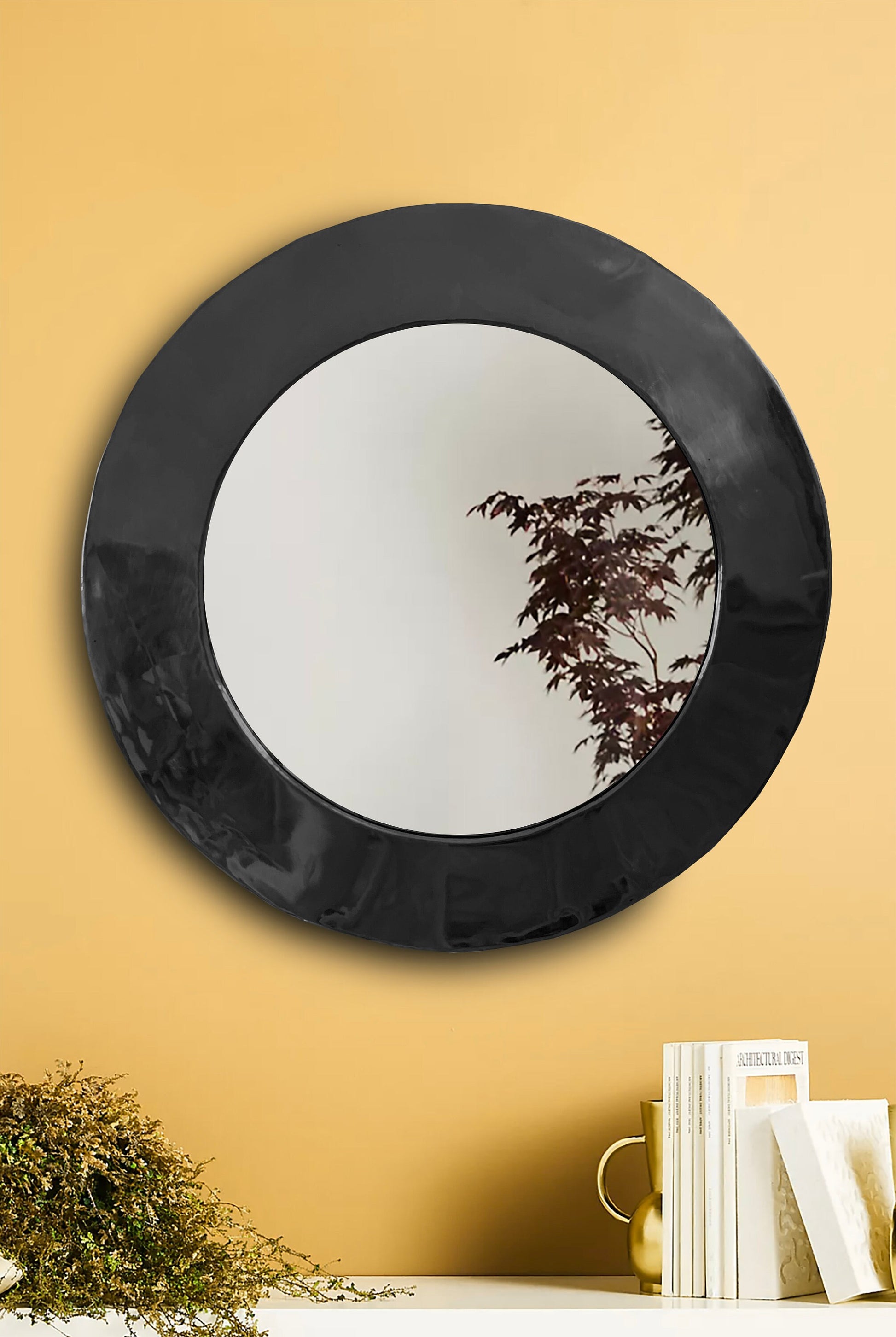 a mirror hanging on a wall above a table