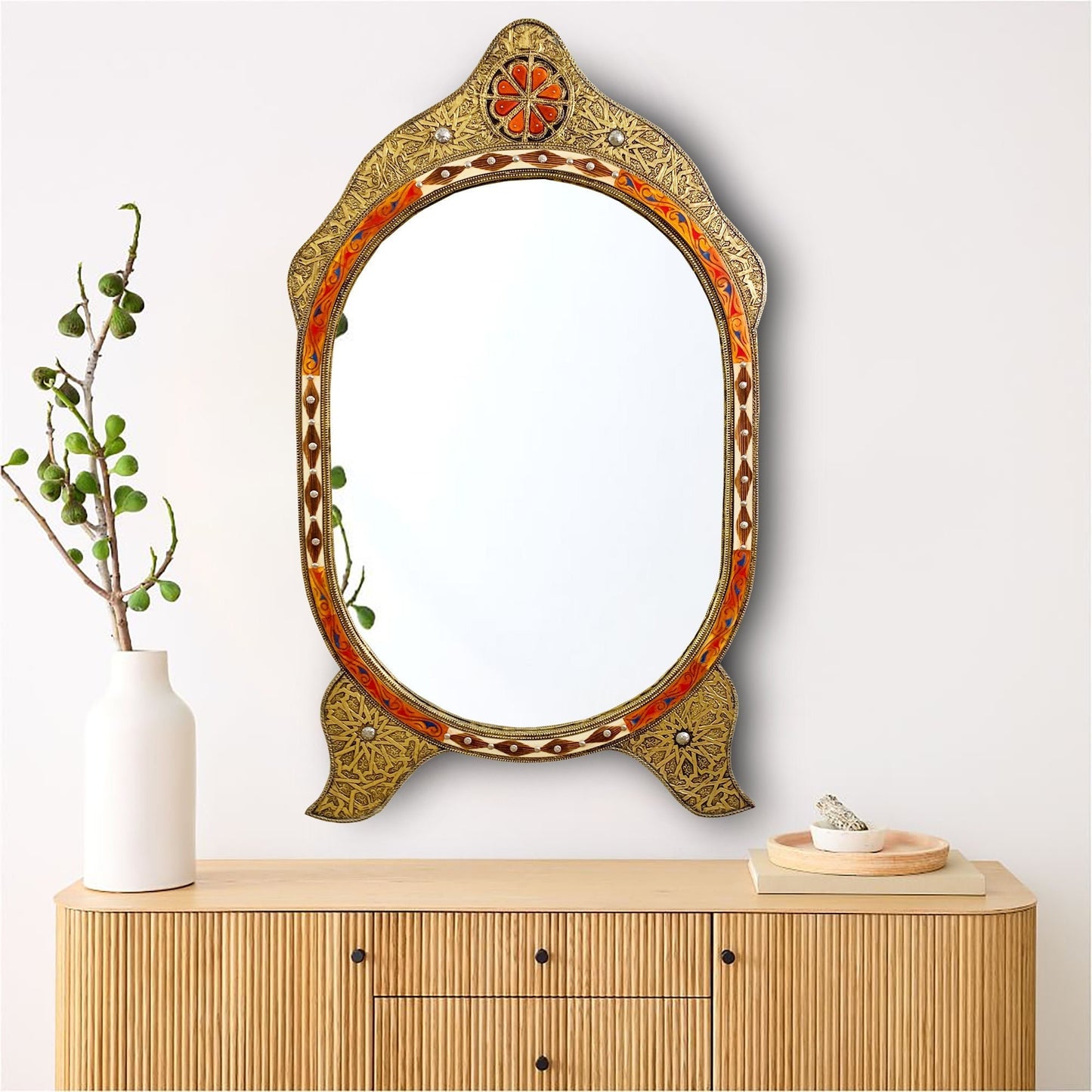 a mirror sitting on top of a wooden dresser