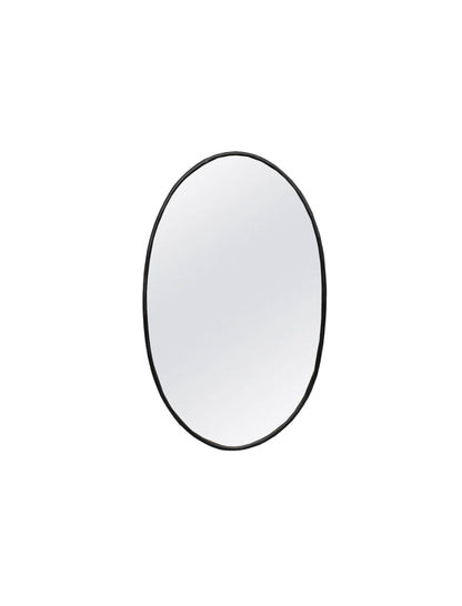 a round mirror on a white wall