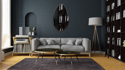 a living room with a couch, coffee table and bookshelf