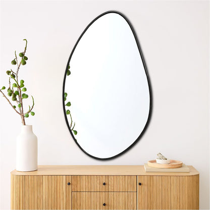 a mirror sitting on top of a wooden dresser