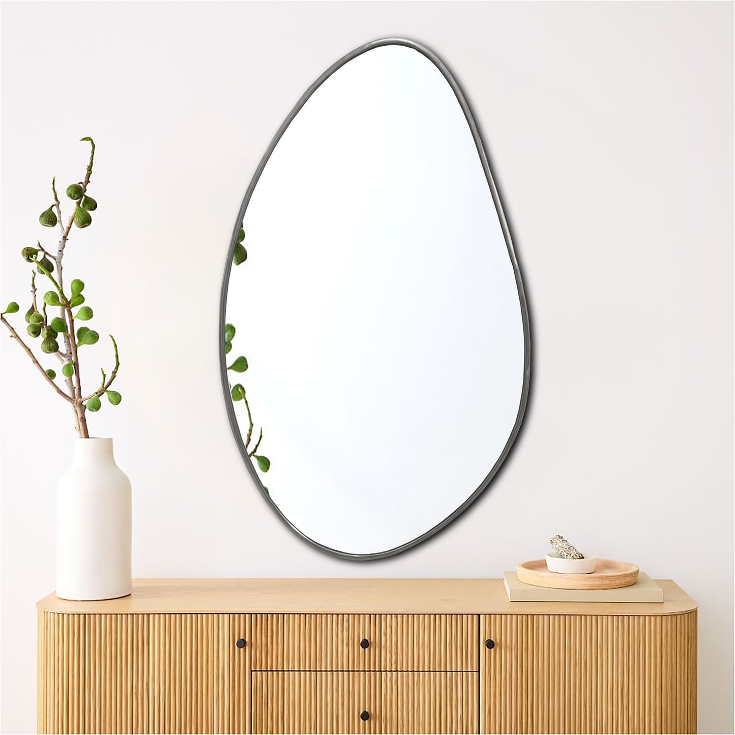 a mirror sitting on top of a wooden dresser