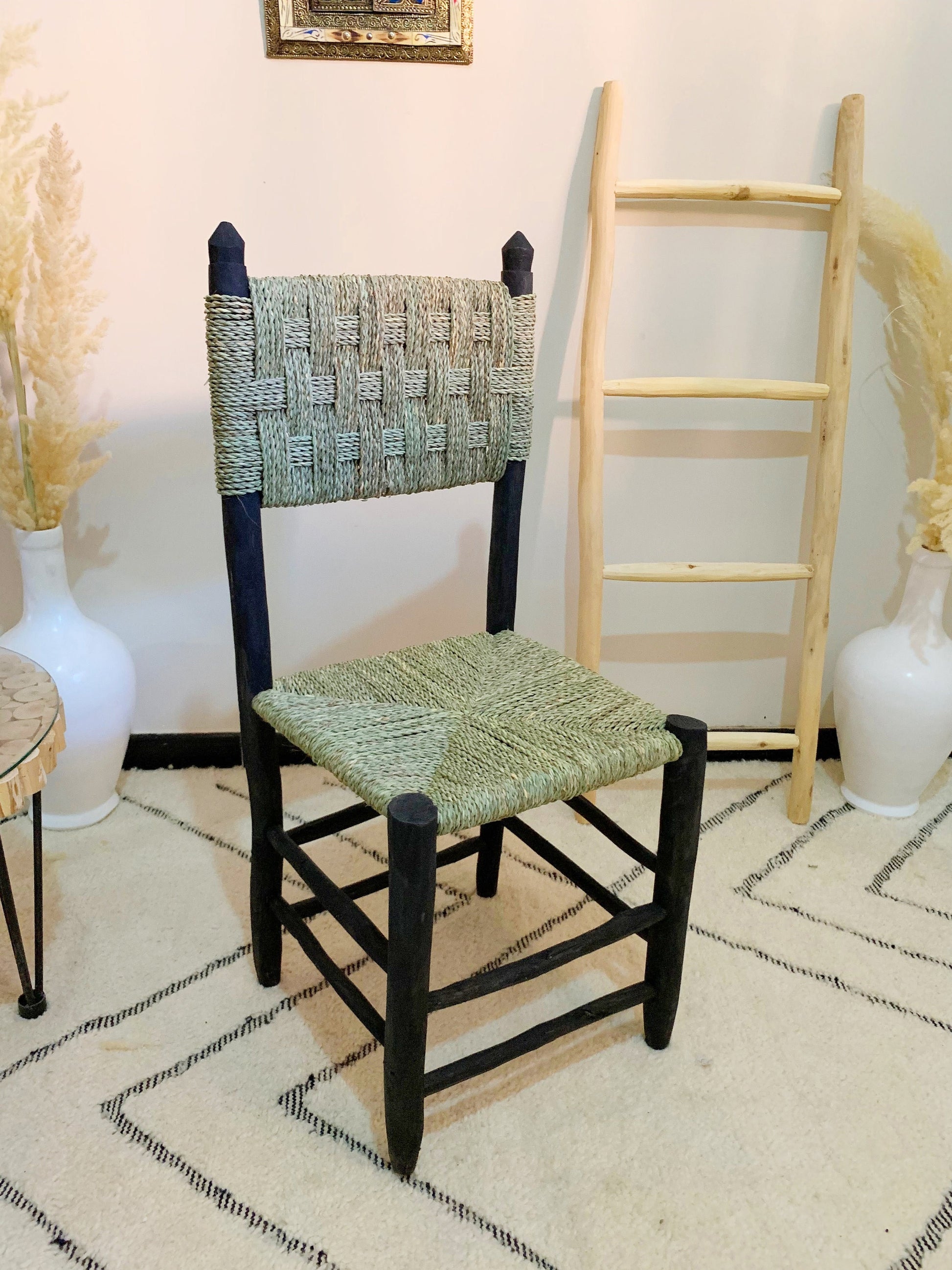 a chair sitting in a room next to a ladder