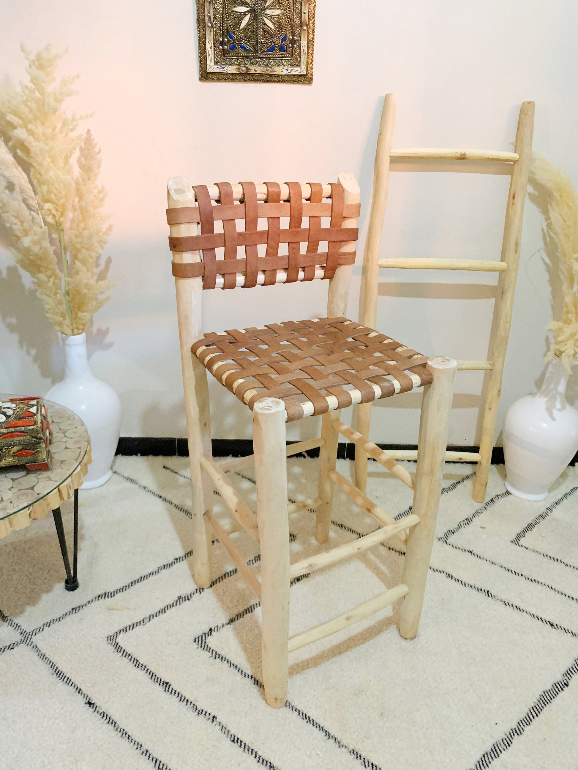 a wooden chair sitting in a room next to a table