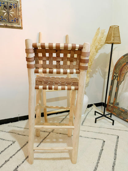 a wooden chair sitting on top of a white rug