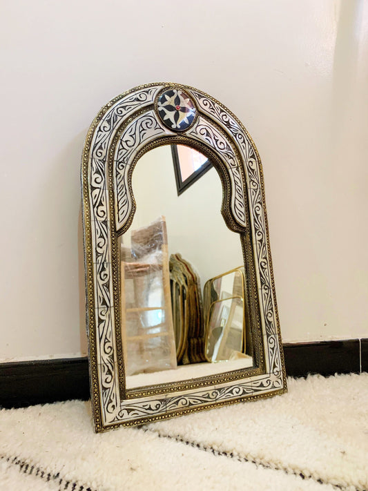 a mirror sitting on top of a white rug