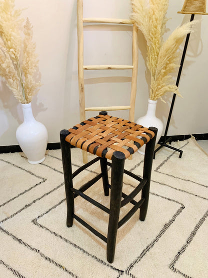 a chair and a vase sitting on a rug