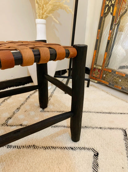 a wooden bench sitting on top of a white rug