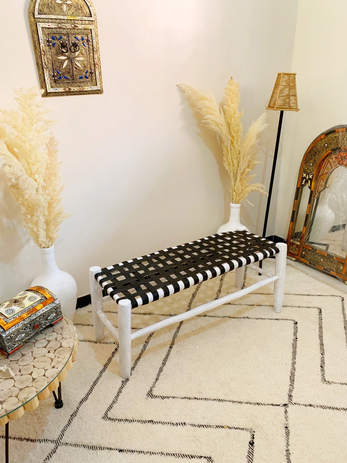 a black and white bench sitting in a living room