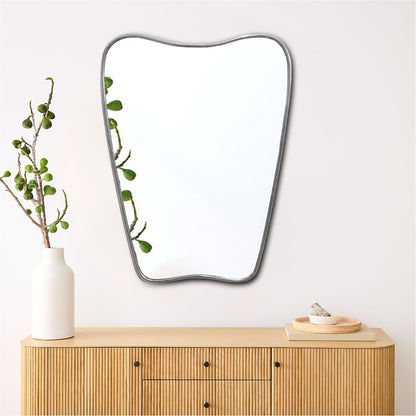 a mirror sitting on top of a wooden dresser