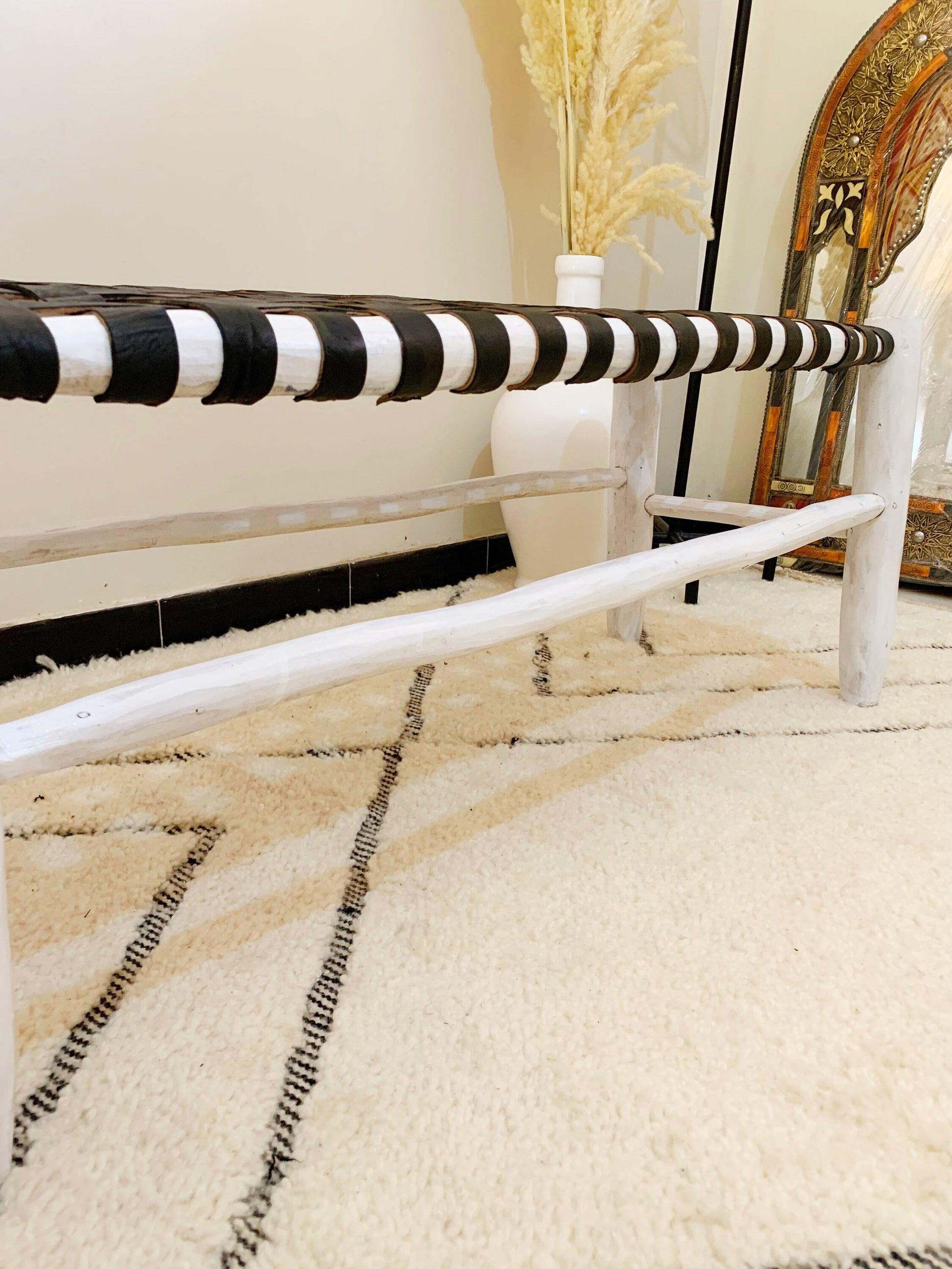 a white rug with black and white stripes on it