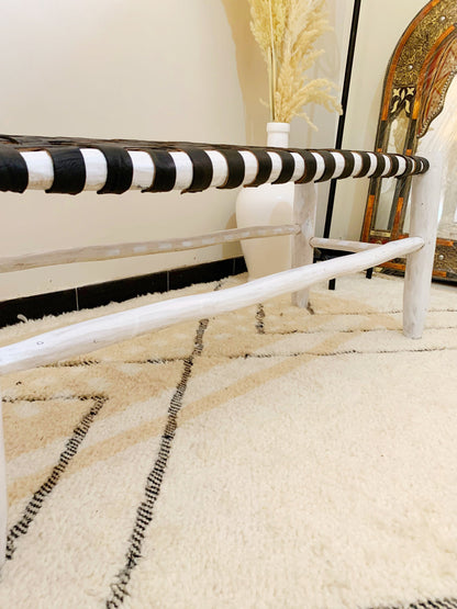 a white rug with black and white stripes on it