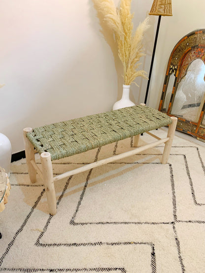 a wooden bench sitting on top of a white rug