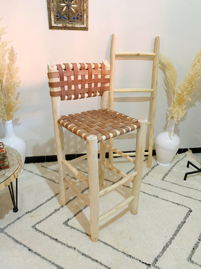 a wooden chair sitting on top of a white rug