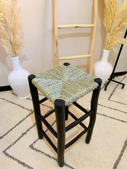 a chair and two vases on a rug