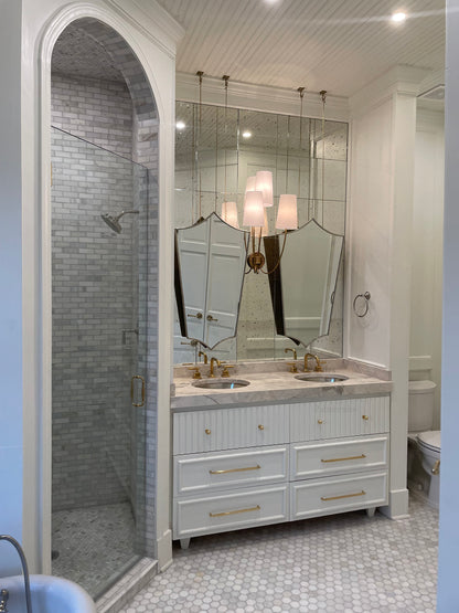 a bathroom with two sinks and a large mirror