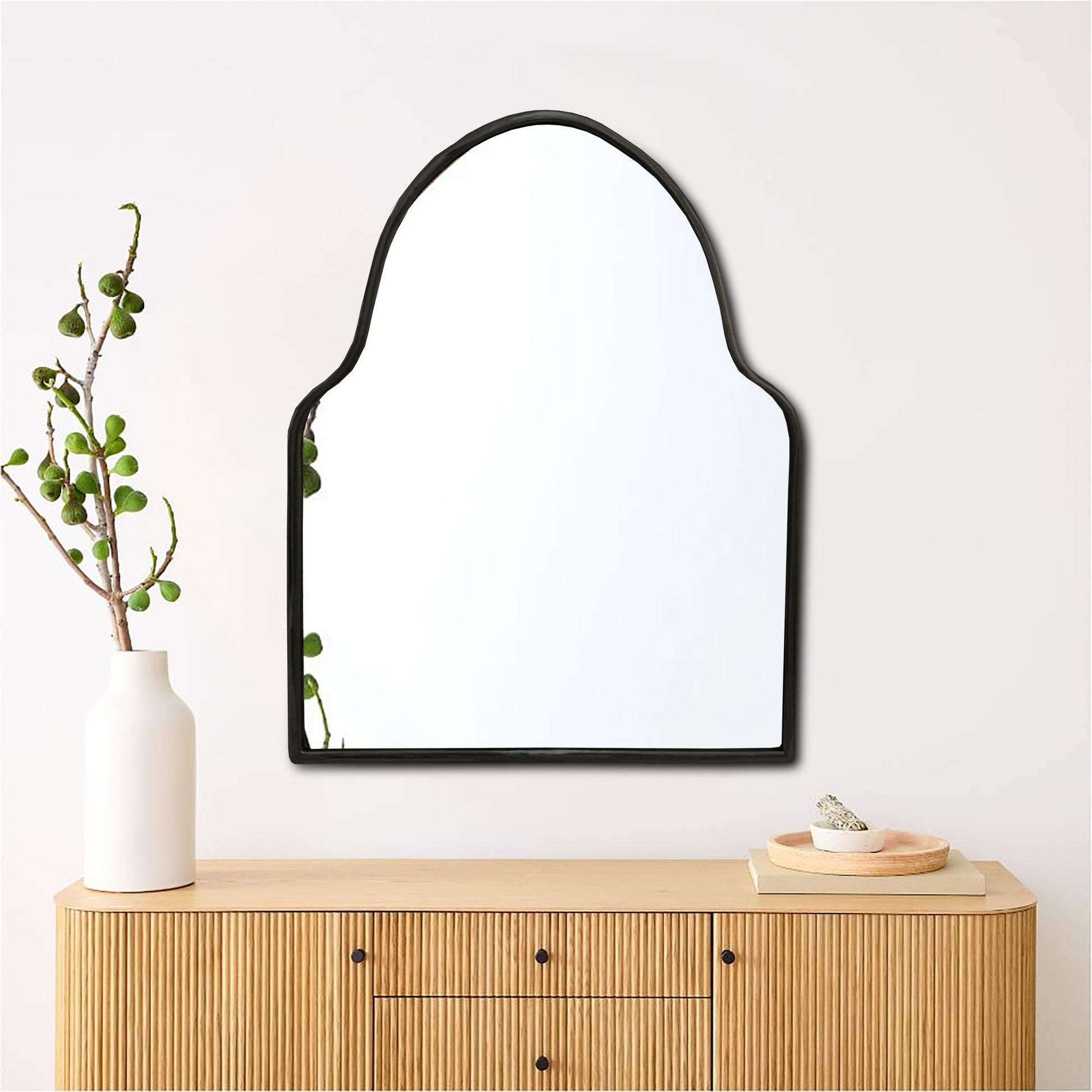 a mirror on a wall above a dresser