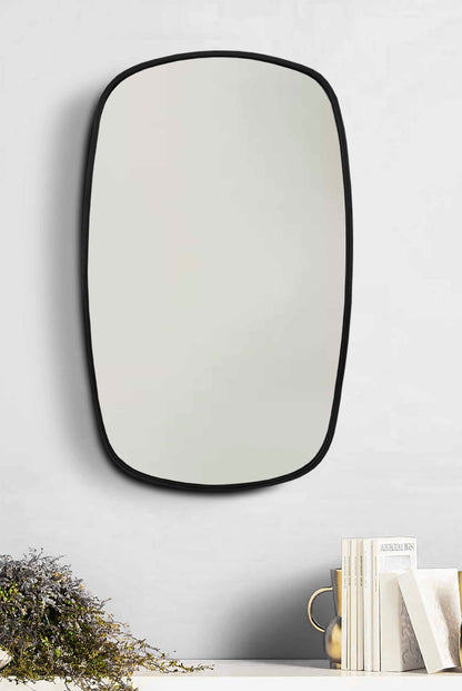 a mirror hanging on the wall above a shelf