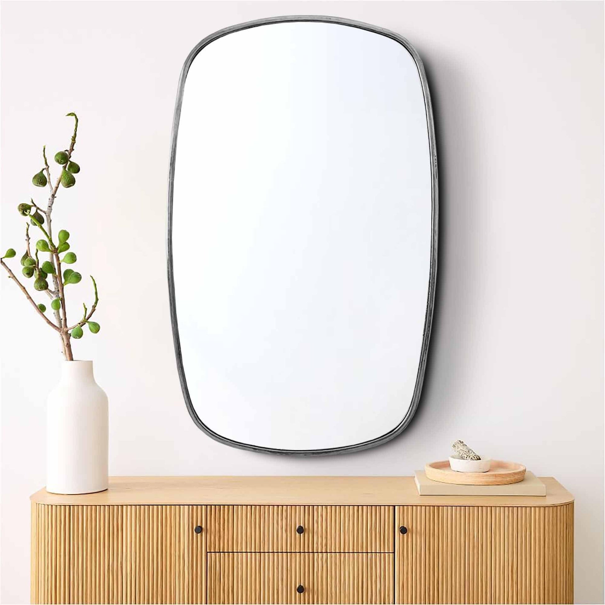 a mirror sitting on top of a wooden dresser