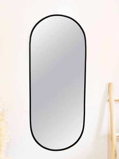 a mirror hanging on a wall next to a chair