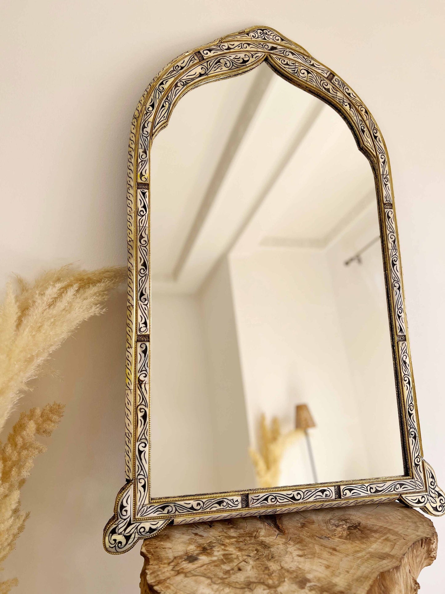 a mirror sitting on top of a wooden table