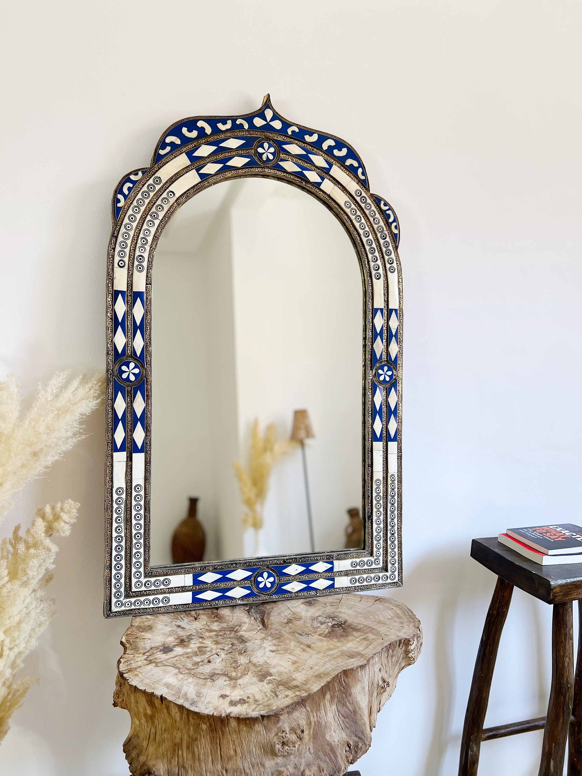 a mirror sitting on top of a wooden table