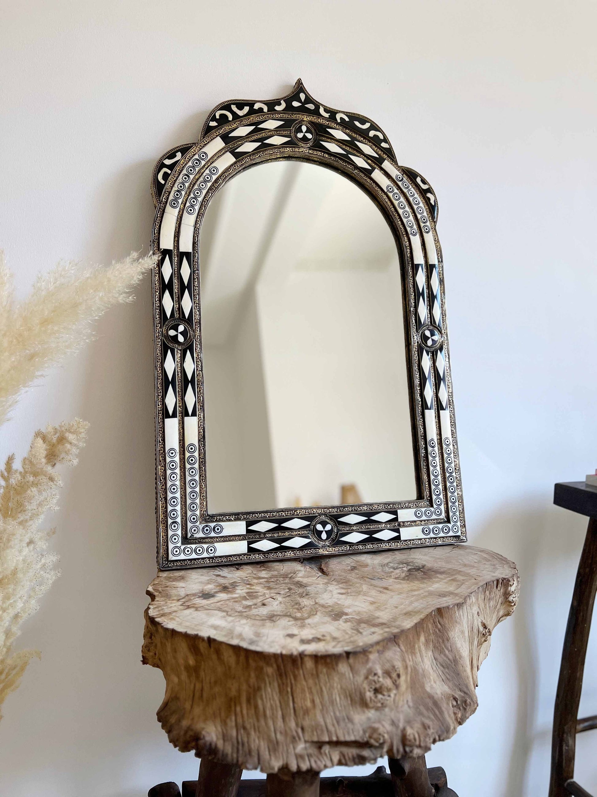 a mirror sitting on top of a wooden table