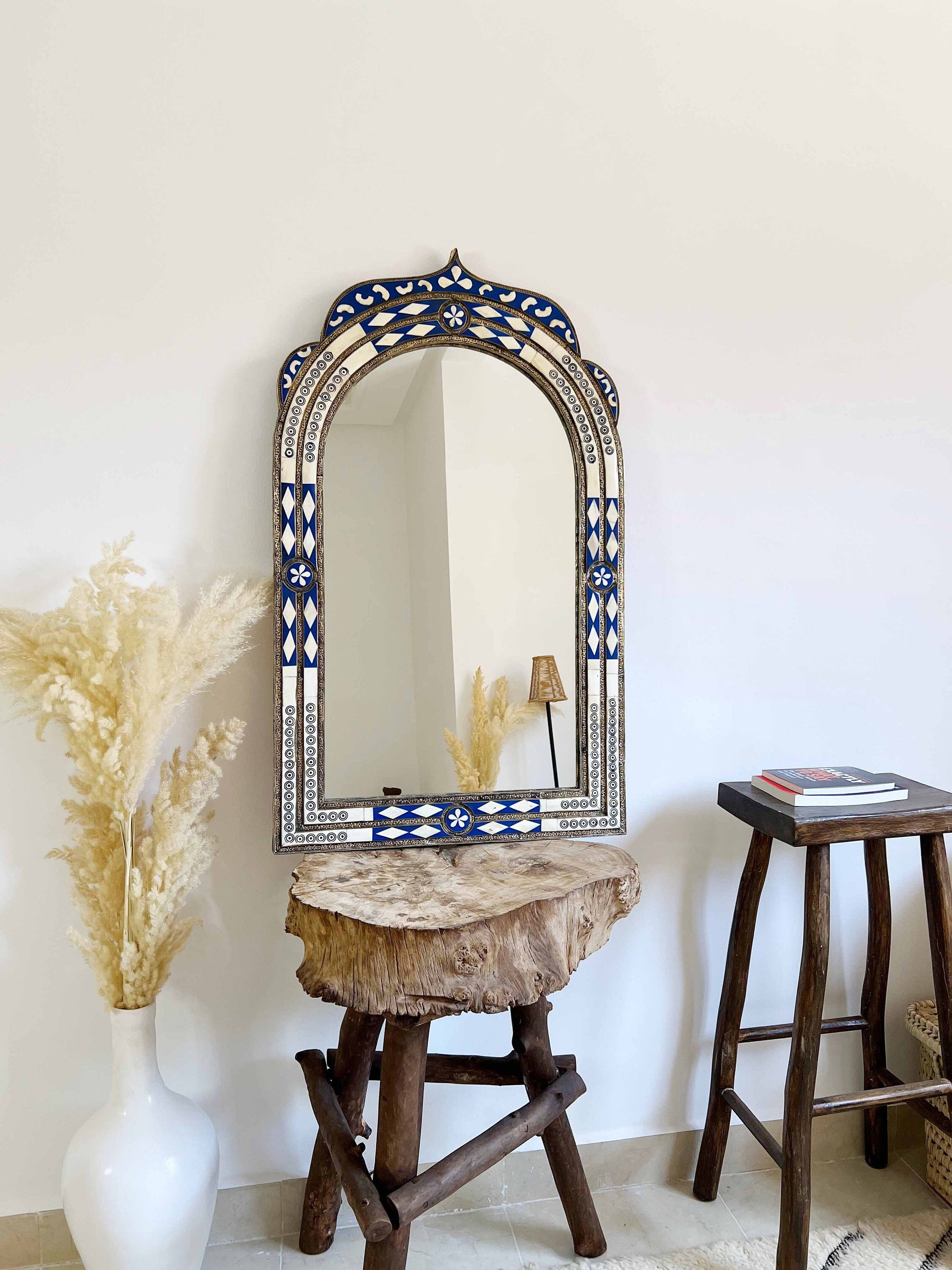 a mirror sitting on top of a wooden table