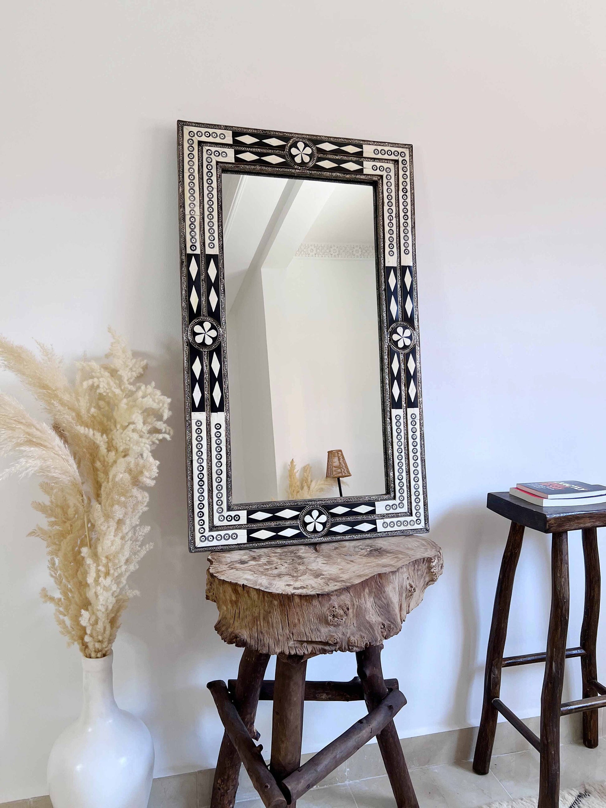 a mirror sitting on top of a wooden table