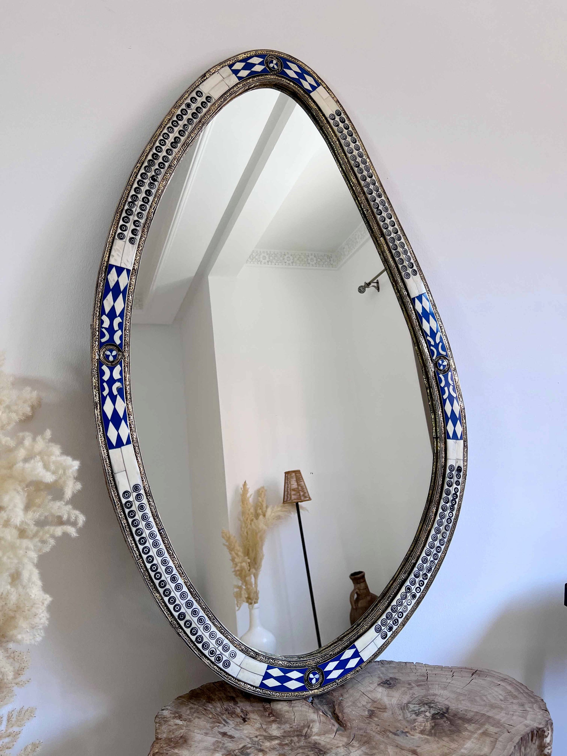 a mirror sitting on top of a wooden table