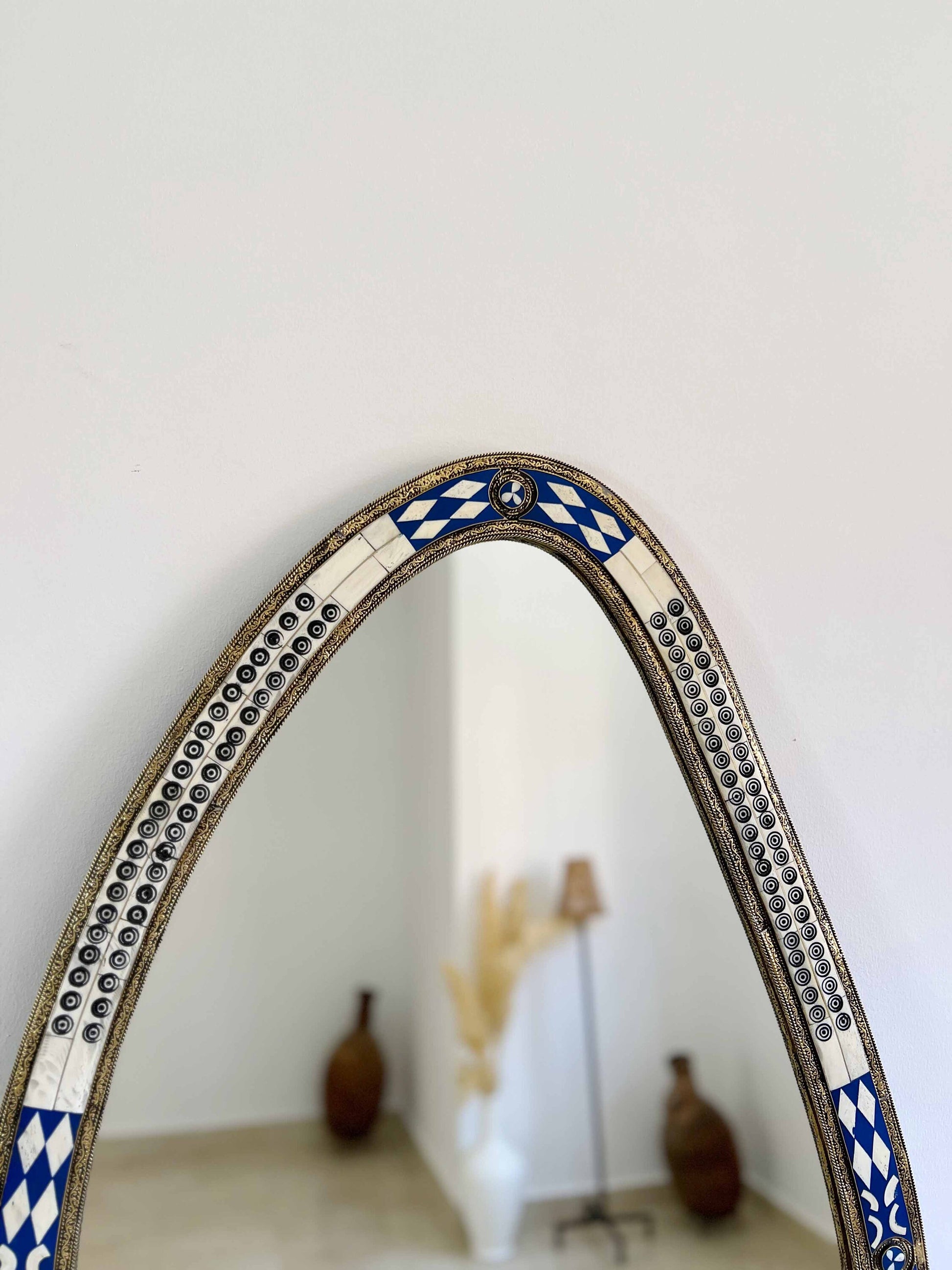 a mirror with a blue and white design on it