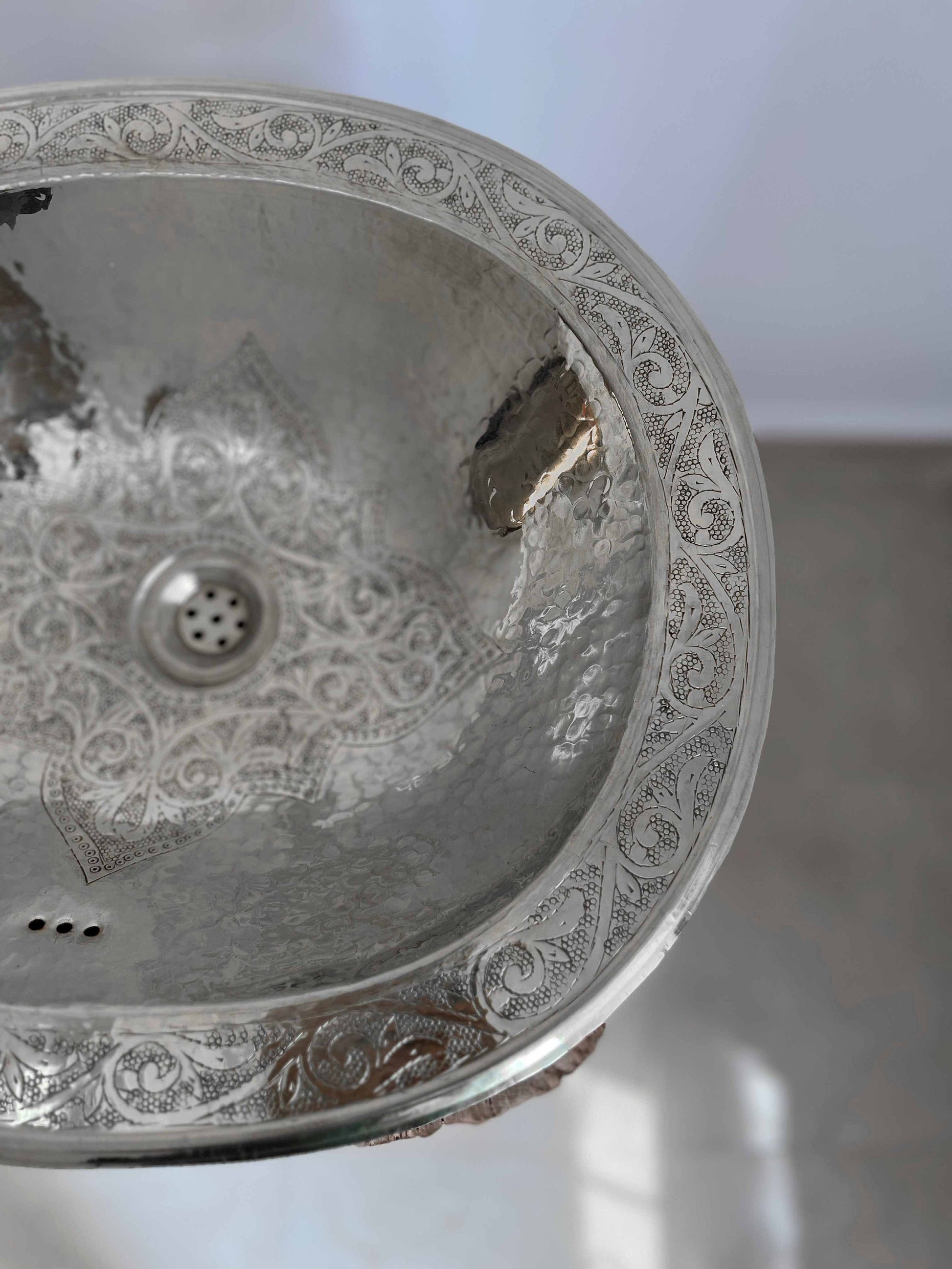 a silver sink sitting on top of a counter