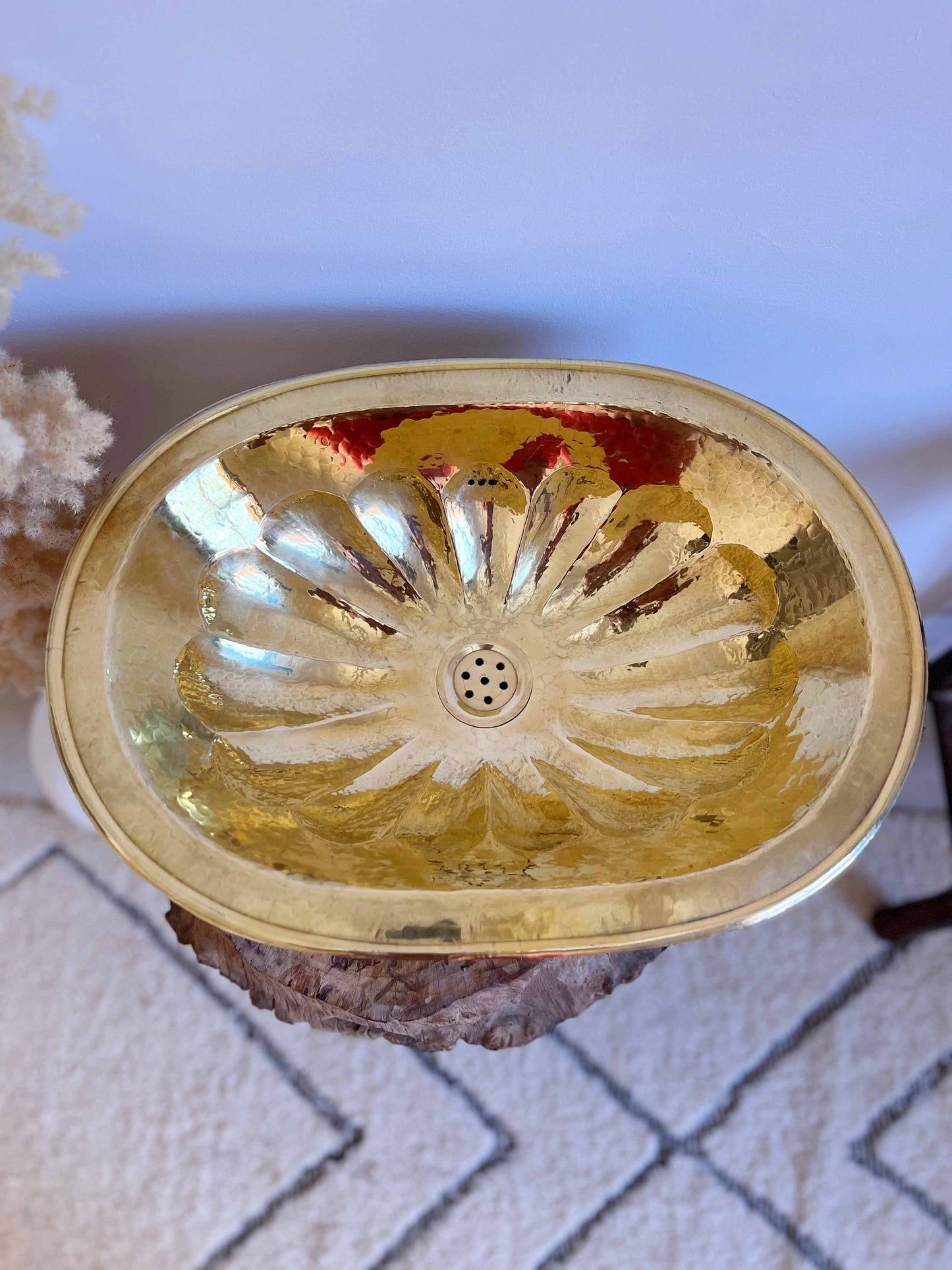 a golden bowl sitting on top of a rock