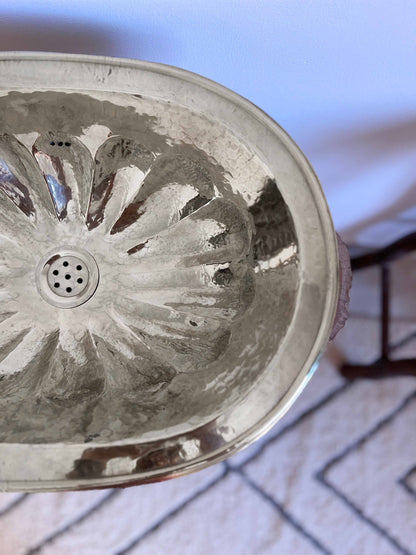 a close up of a metal bowl on a table