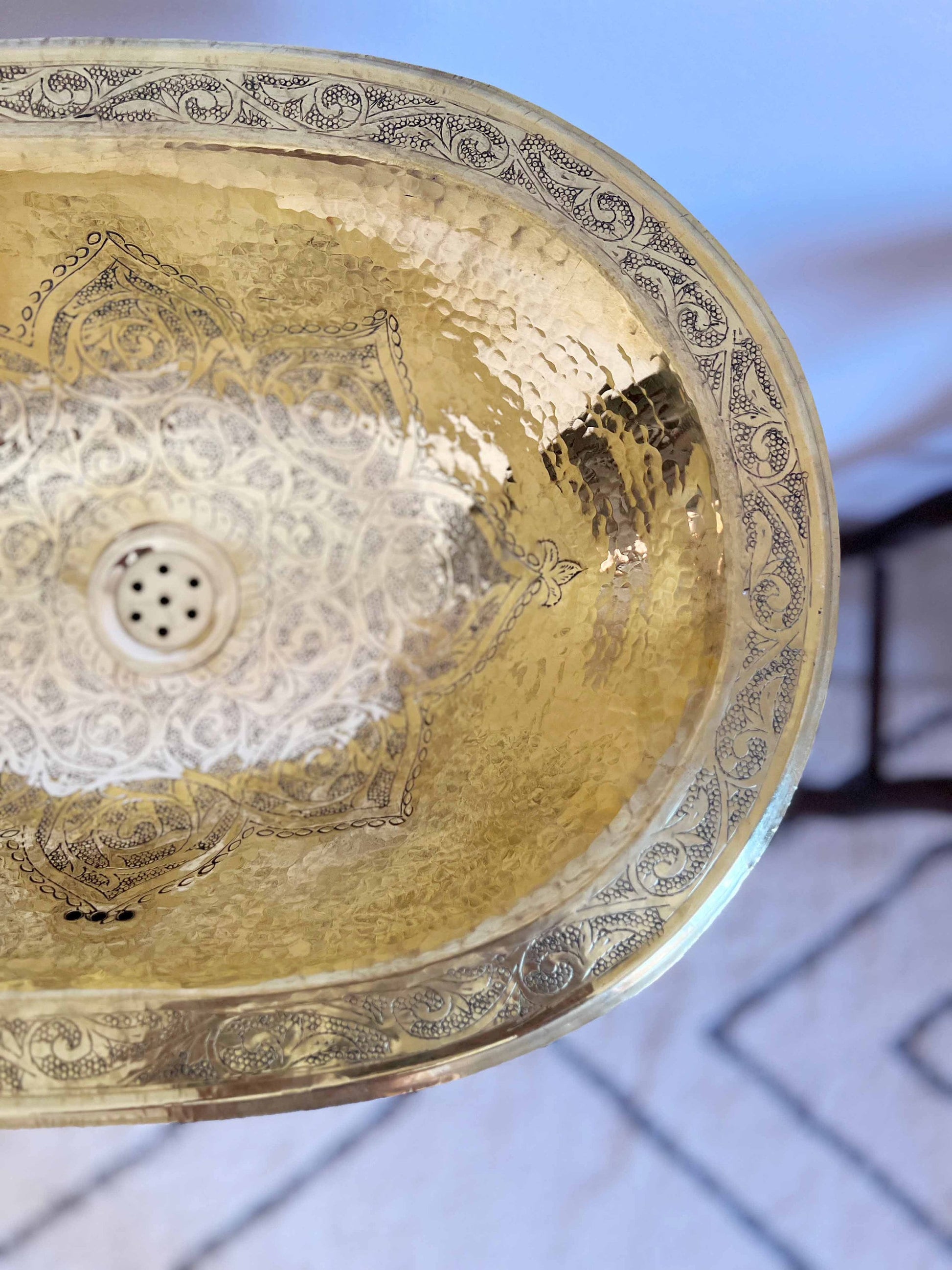 a golden bowl shaped sink hanging from a ceiling