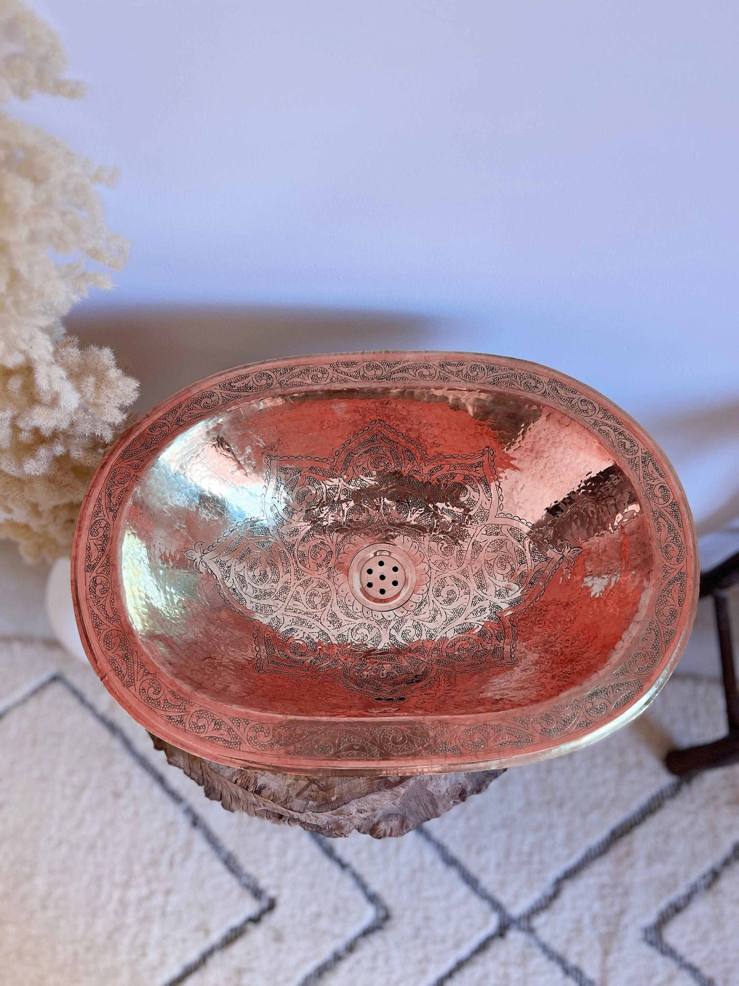 a red sink sitting on top of a white rug