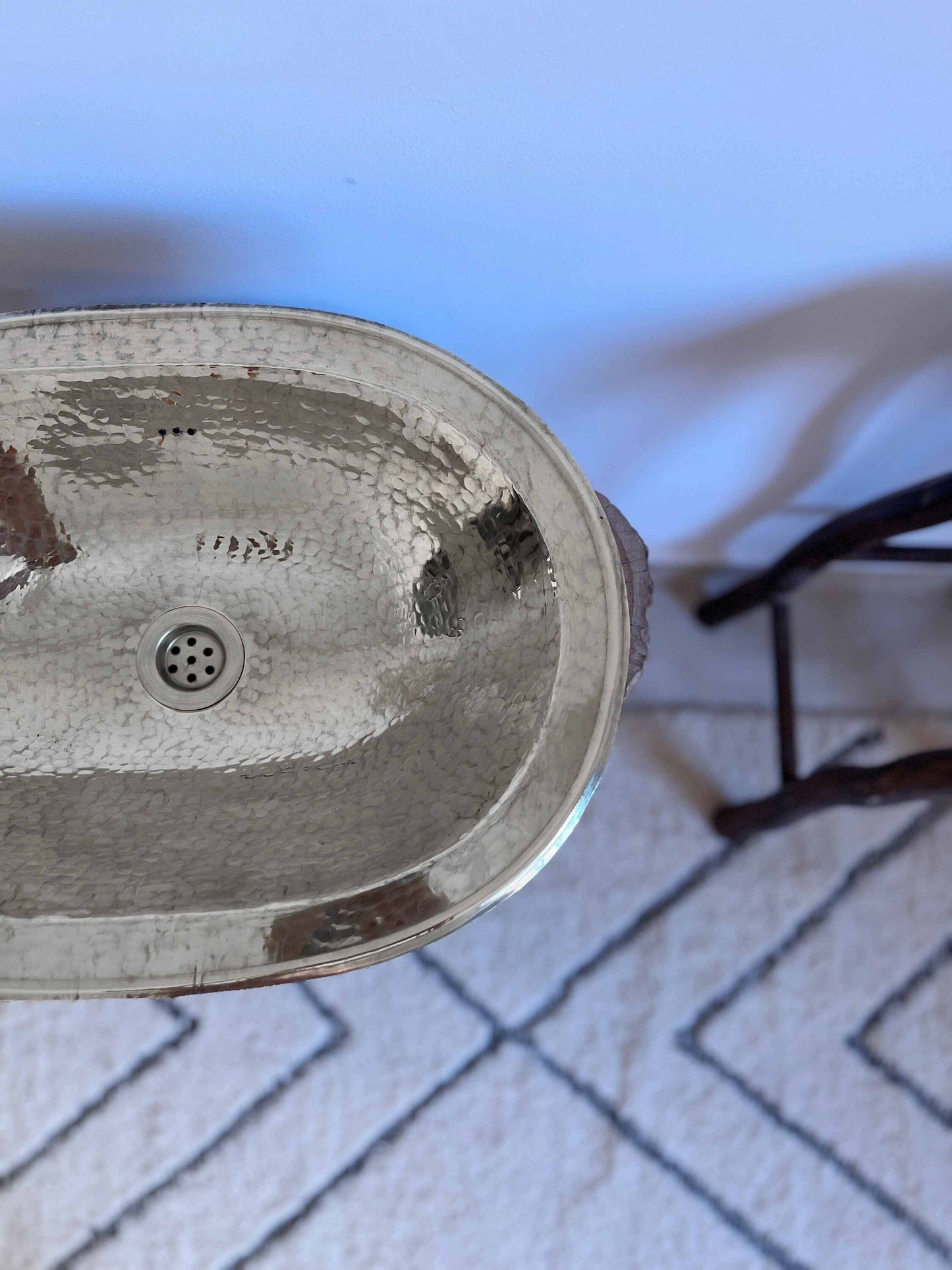 a bathroom sink sitting on top of a white rug