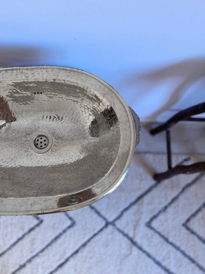 a bathroom sink sitting on top of a white rug