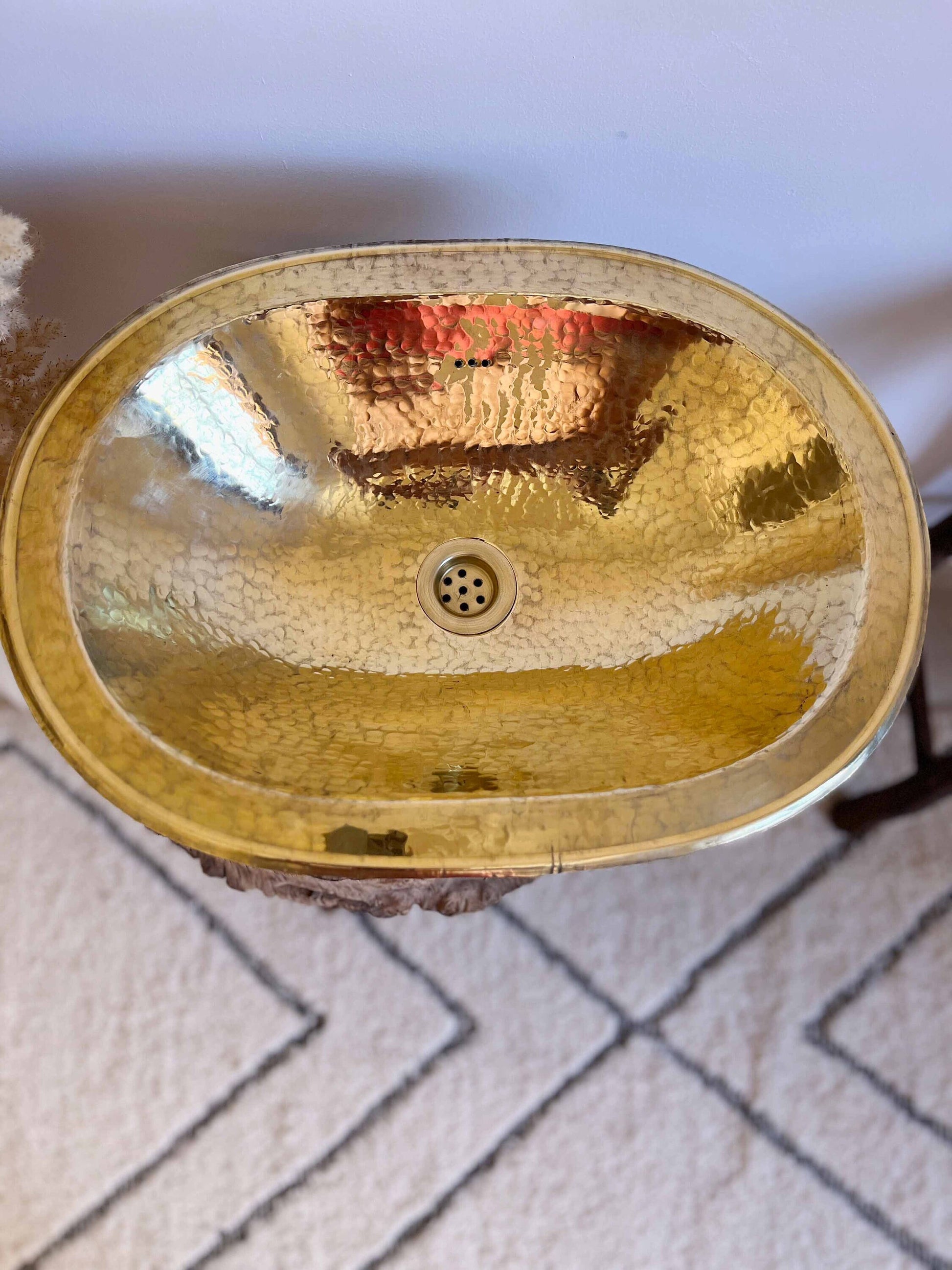 a bathroom sink that is gold in color