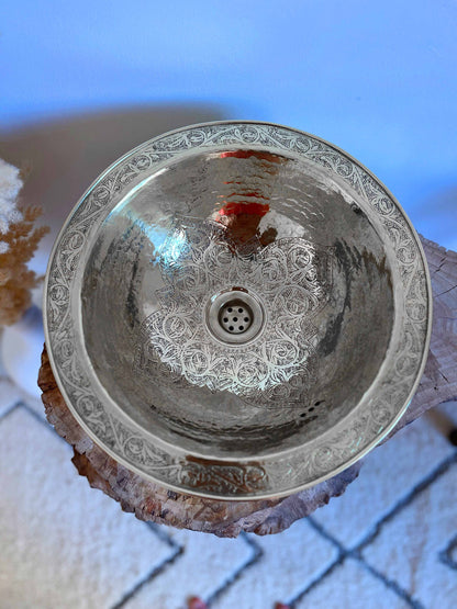 a glass sink sitting on top of a counter