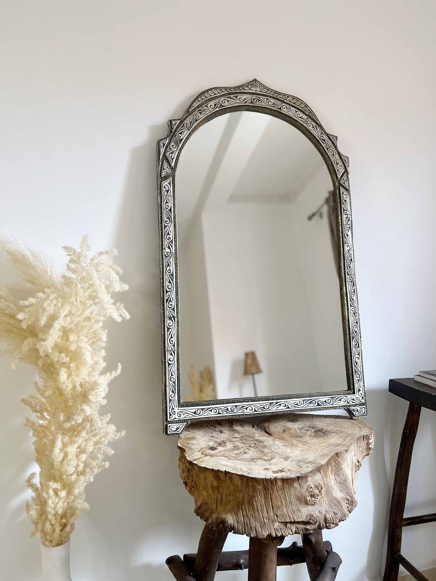 a mirror sitting on top of a wooden table