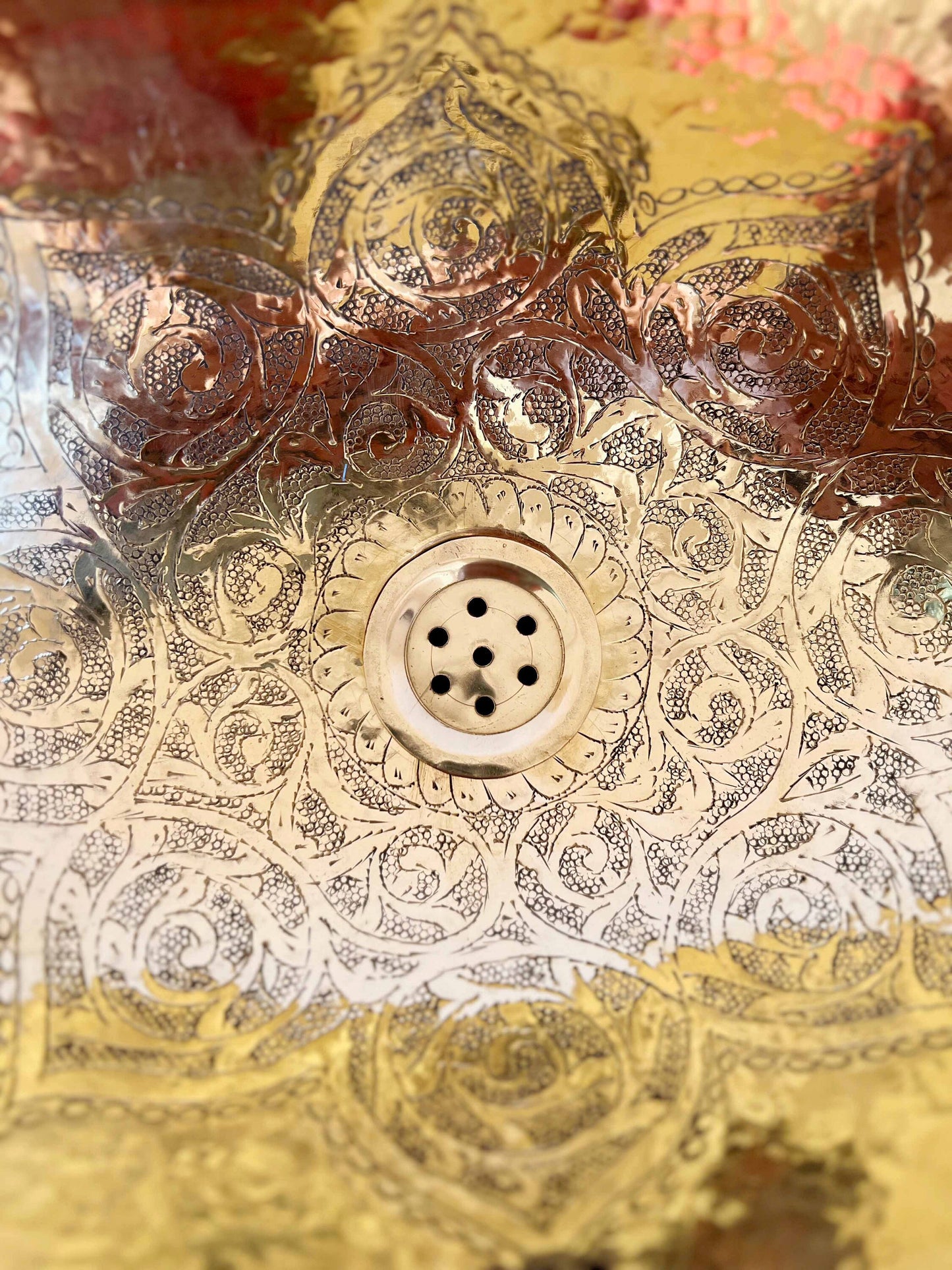 a close up of a sink with a decorative pattern on it