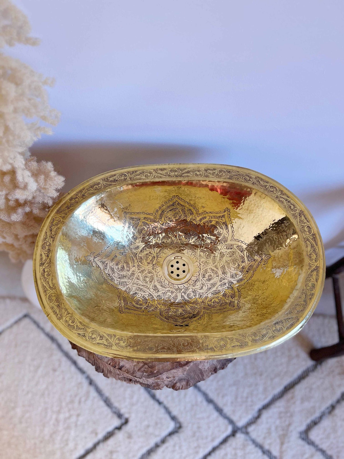 a gold sink sitting on top of a white rug