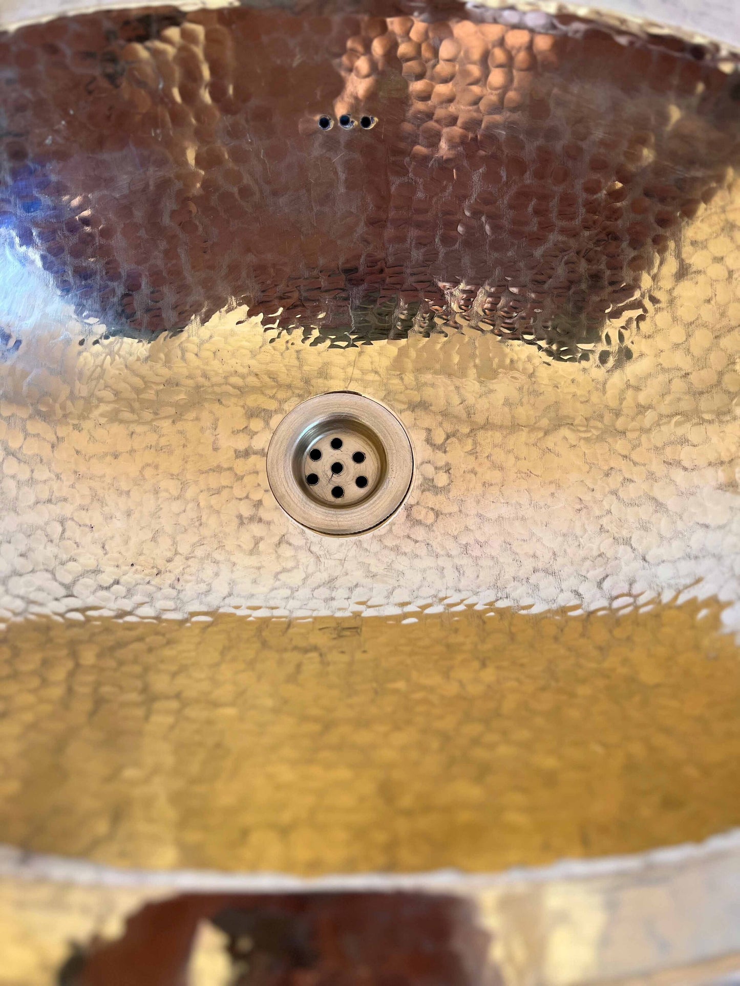 a close up of a metal sink with a drain