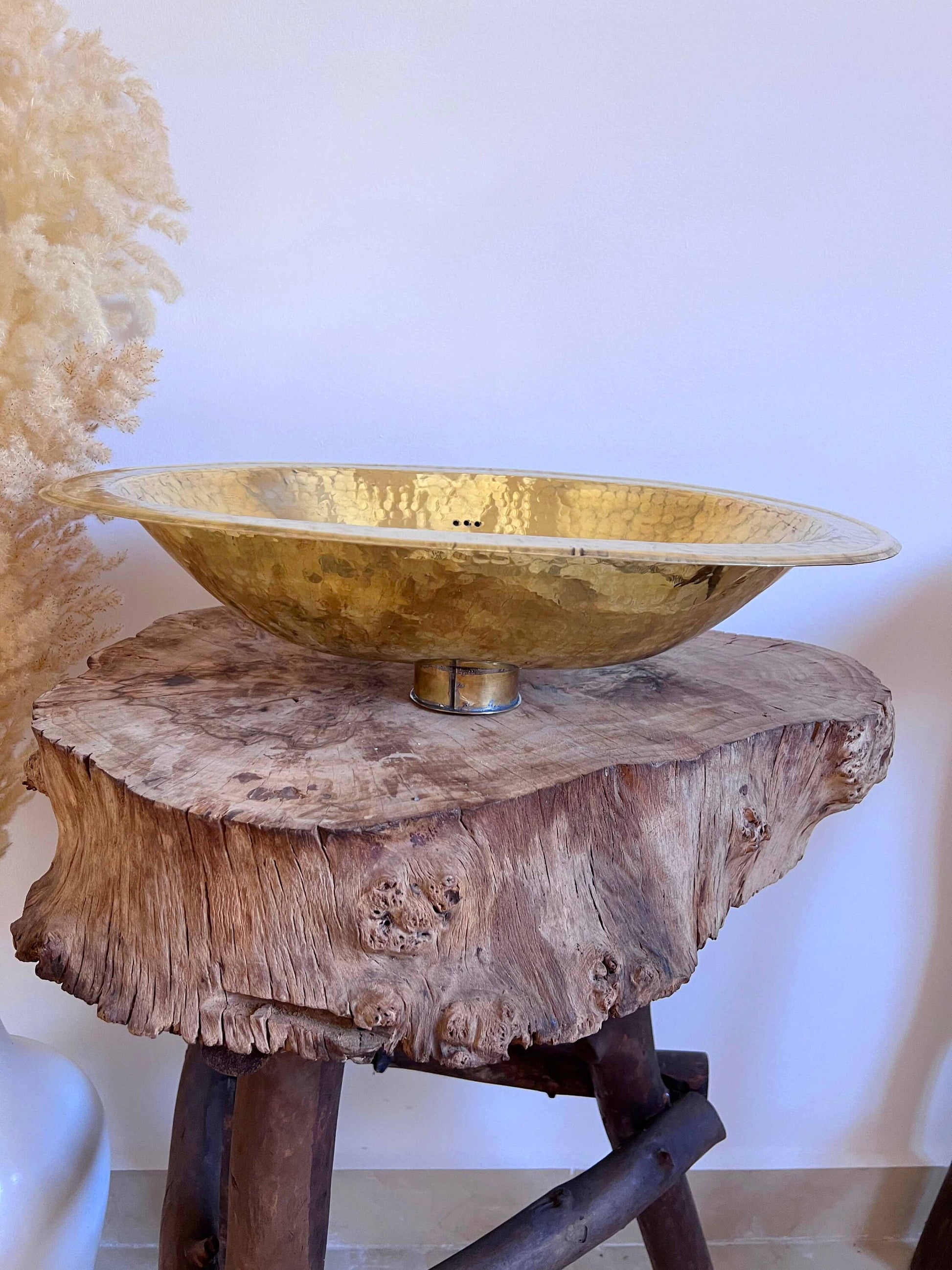 a wooden table with a metal bowl on top of it